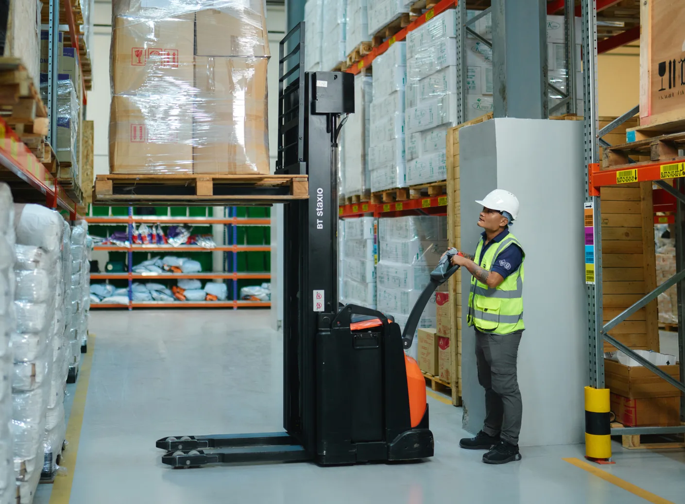 An SLGT operator moving a pallet through the warehouse